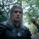 Geralt of Rivia stands in a forest in the Witcher season two trailer.